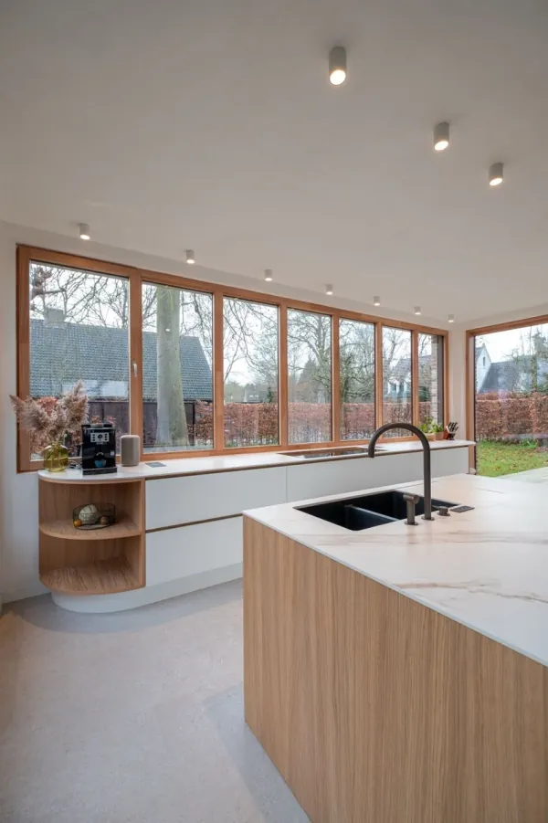Keuken met eiken eiland en ronde open kast aan het raam, realisatie van ID Interieur