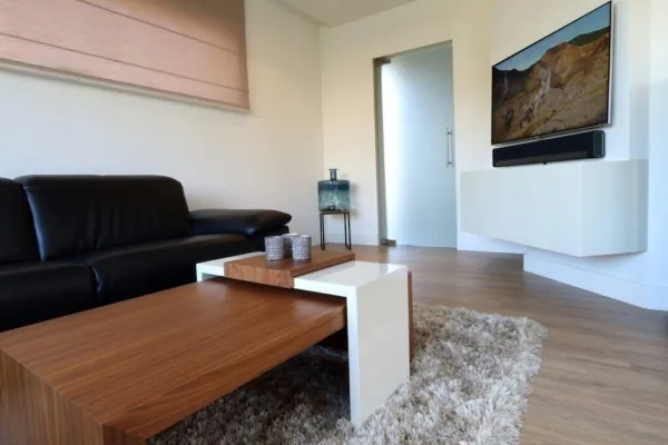 Woonkamer met zwevend wit tv-meubel, realisatie van ID Interieur